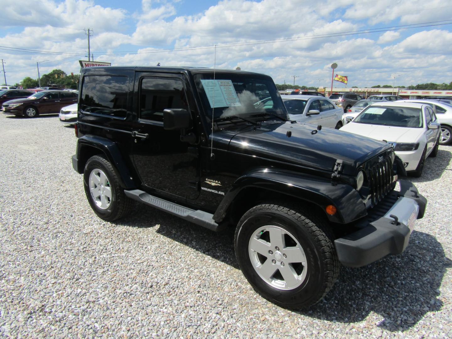 2012 Black /Tan Jeep Wrangler Sahara 4WD (1C4GJWBG2CL) with an 3.6L V6 DOHC 24V FFV engine, Automatic transmission, located at 15016 S Hwy 231, Midland City, AL, 36350, (334) 983-3001, 31.306210, -85.495277 - Photo#0